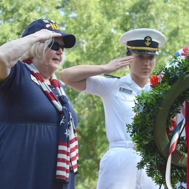 Student saluting a wreath