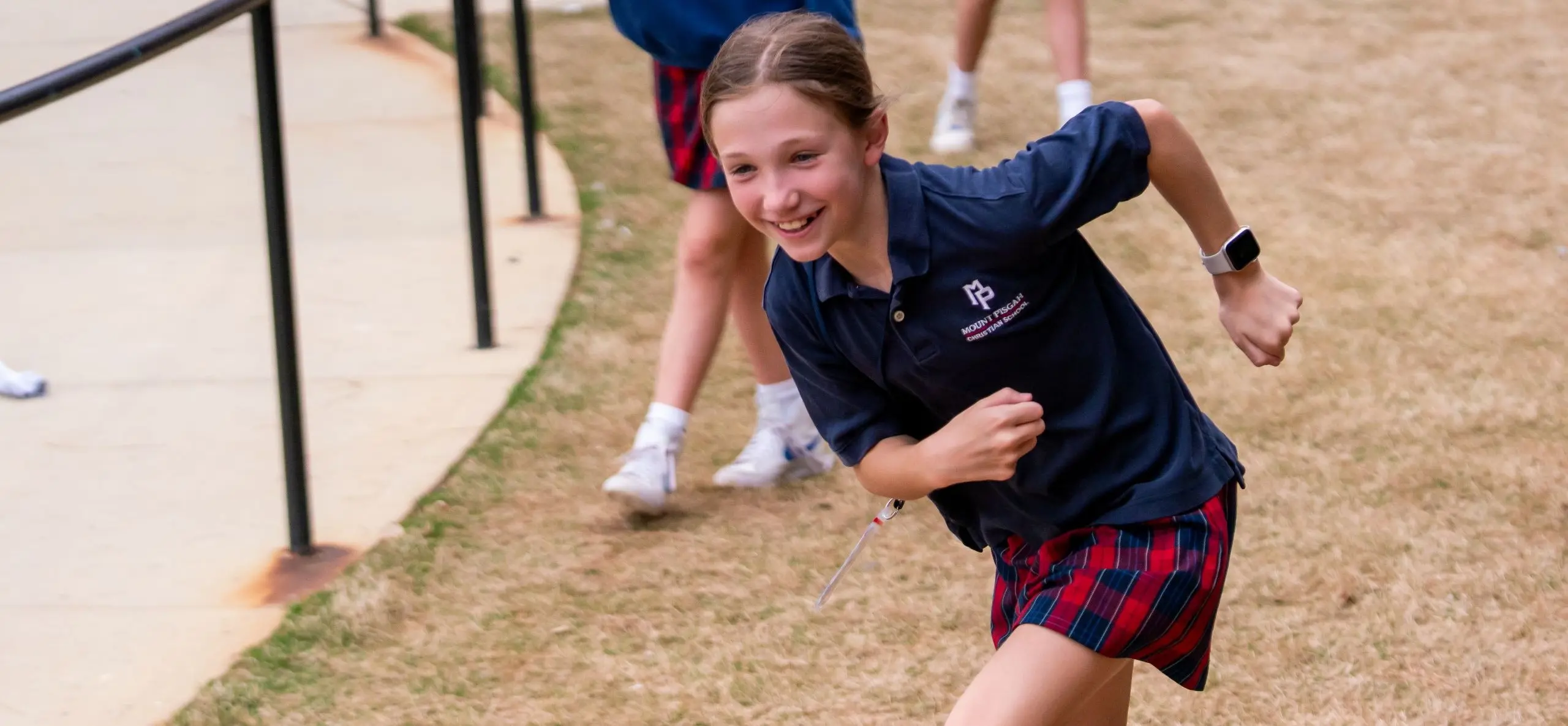 Student running outside, wearing a smartwatch