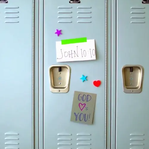 A locker with "John 10:10" and "God loves you!" written on it.