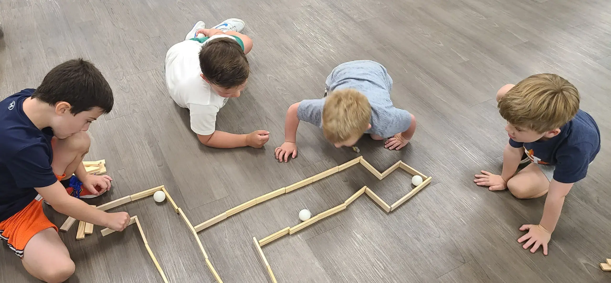 Children playing with a wooden maze
