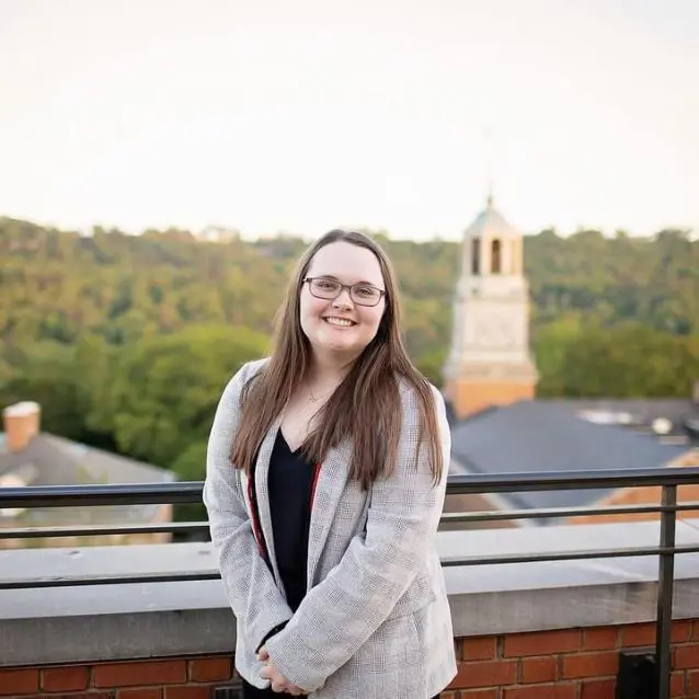 Caroline smiling against railings