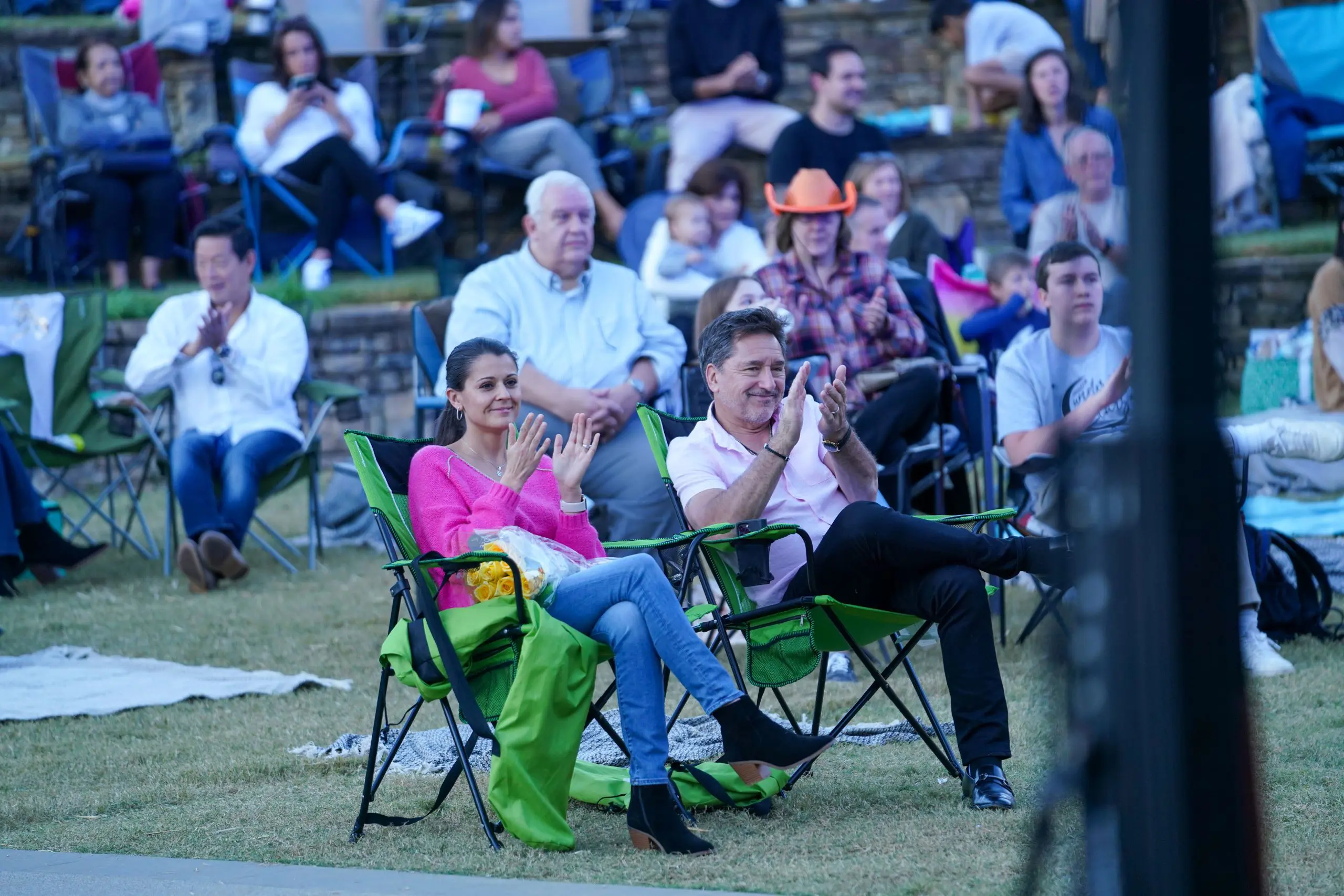 People on deck chairs clapping