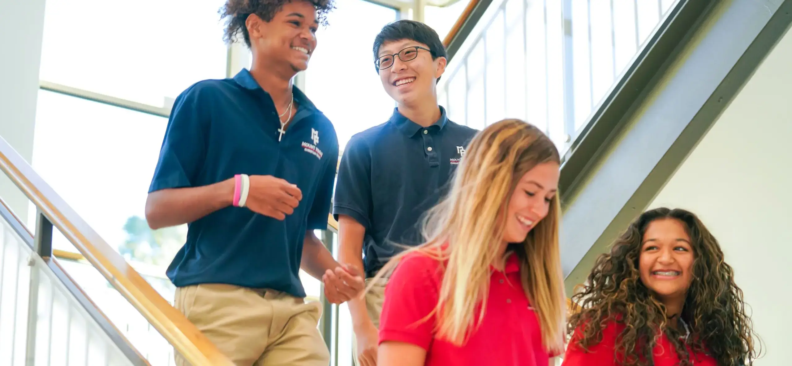 Four students walking down stairs