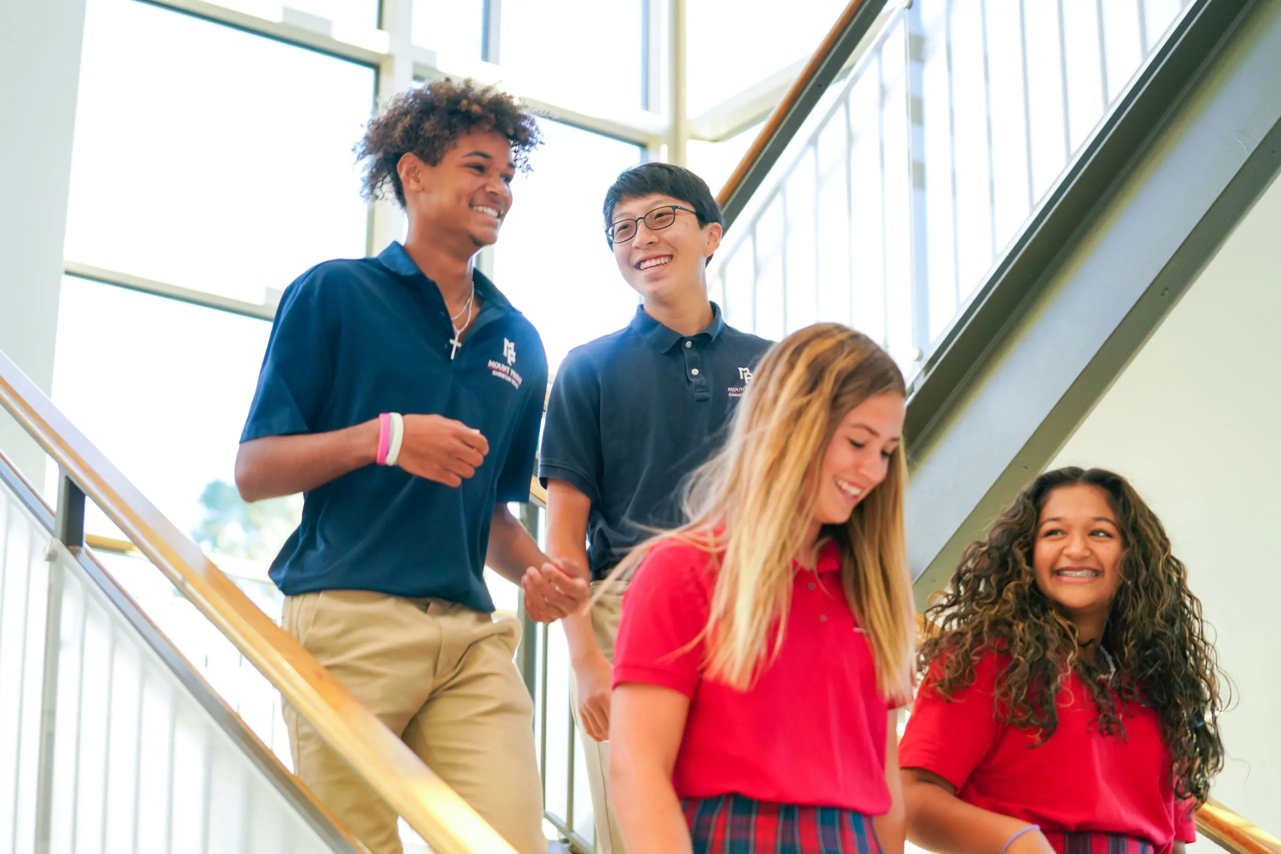 Four students walking down stairs