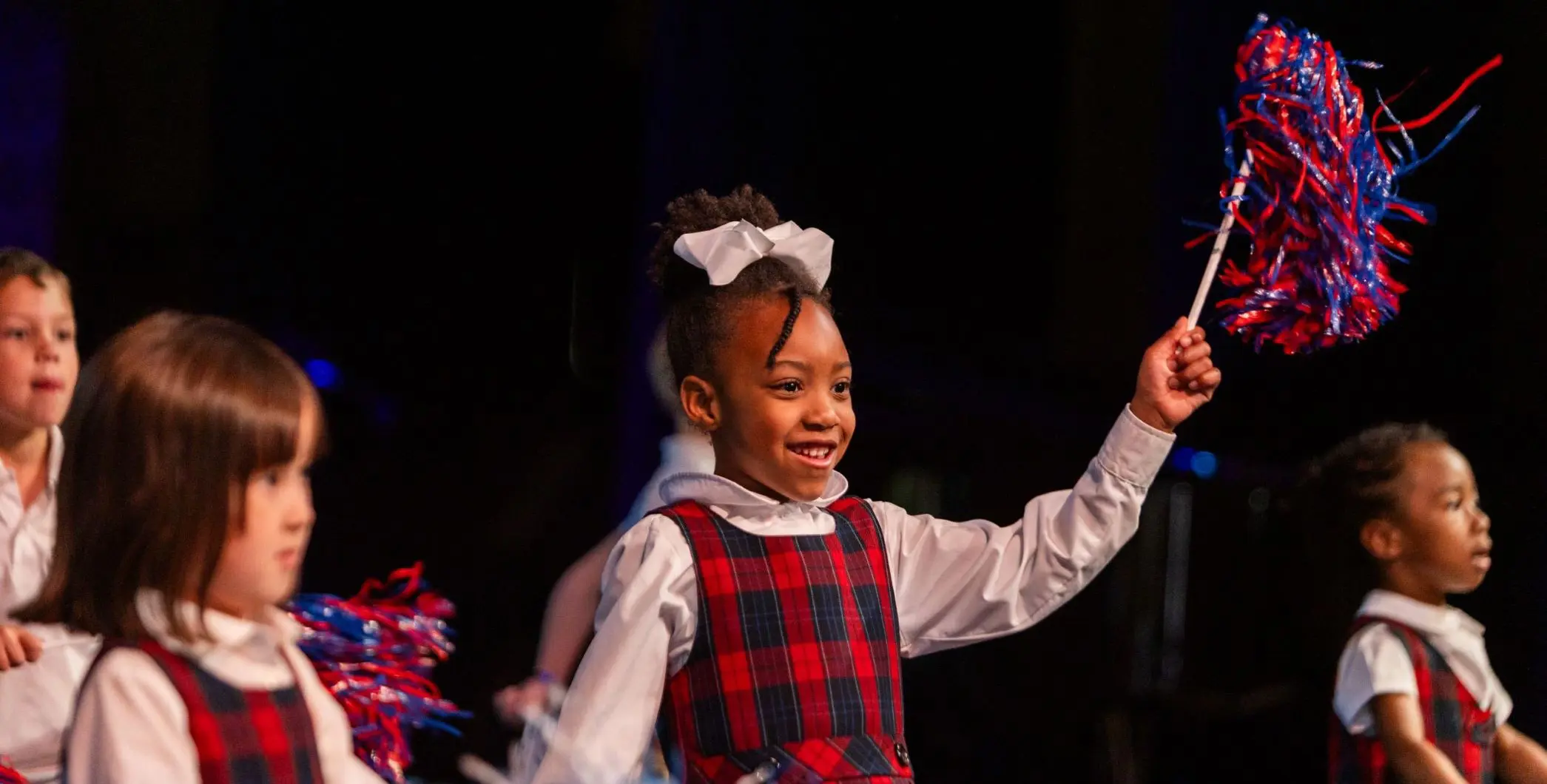 Children waving pompoms