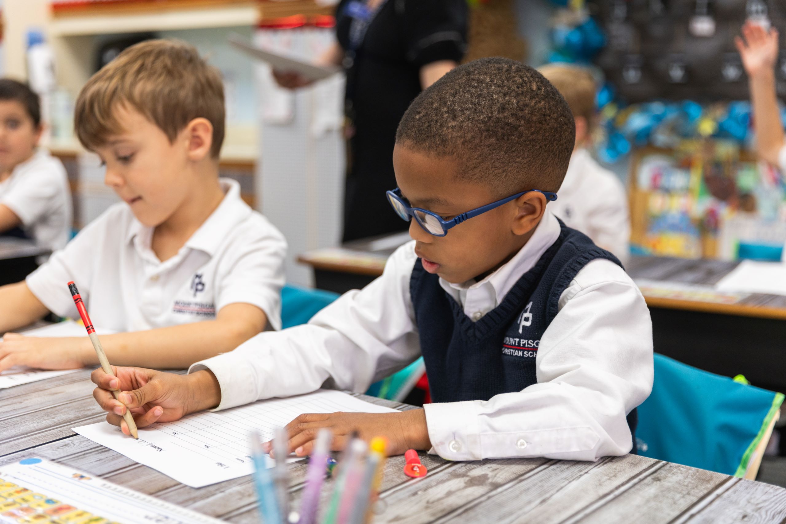 Young boy writing on a piece of paper