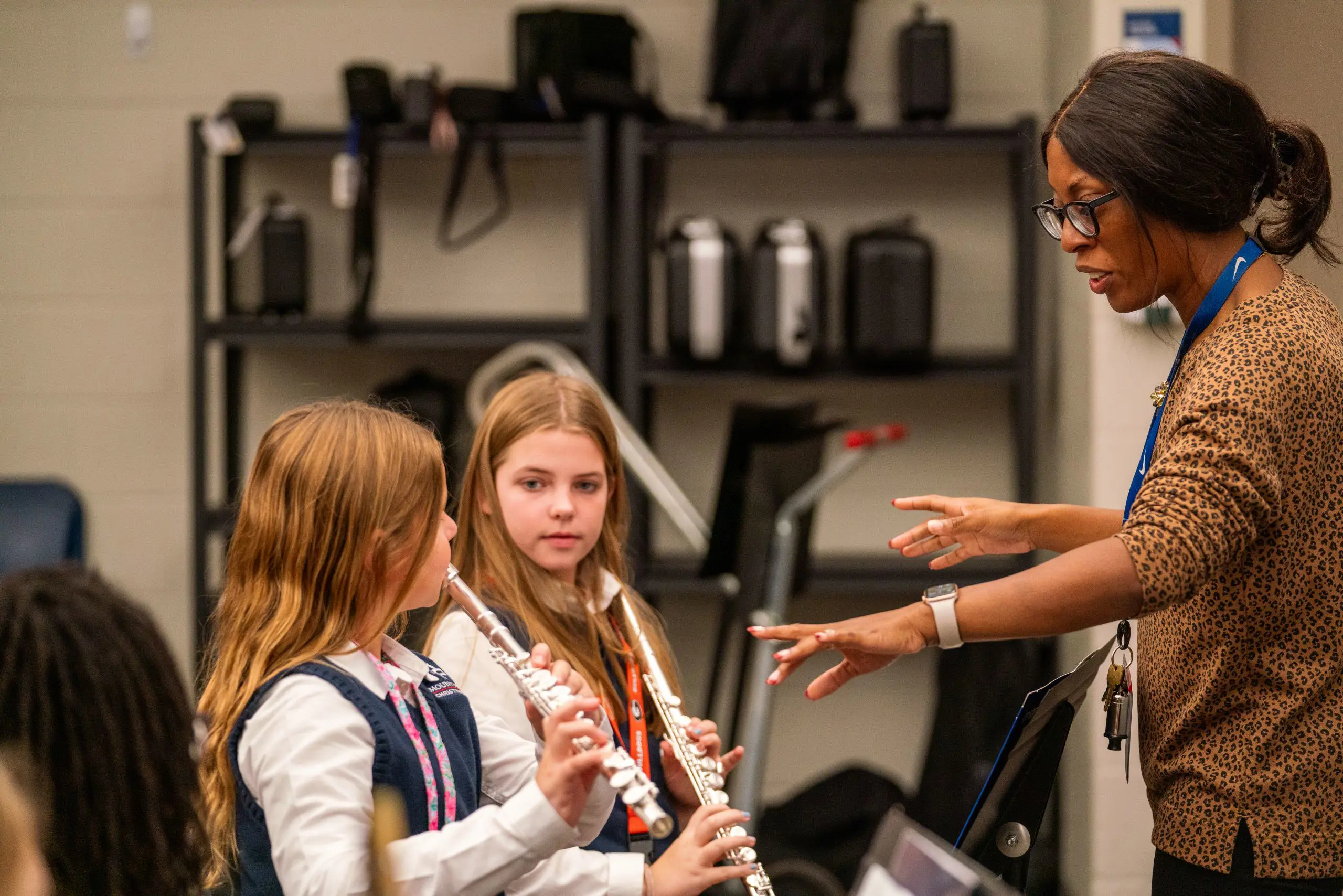 Teacher instructing music students