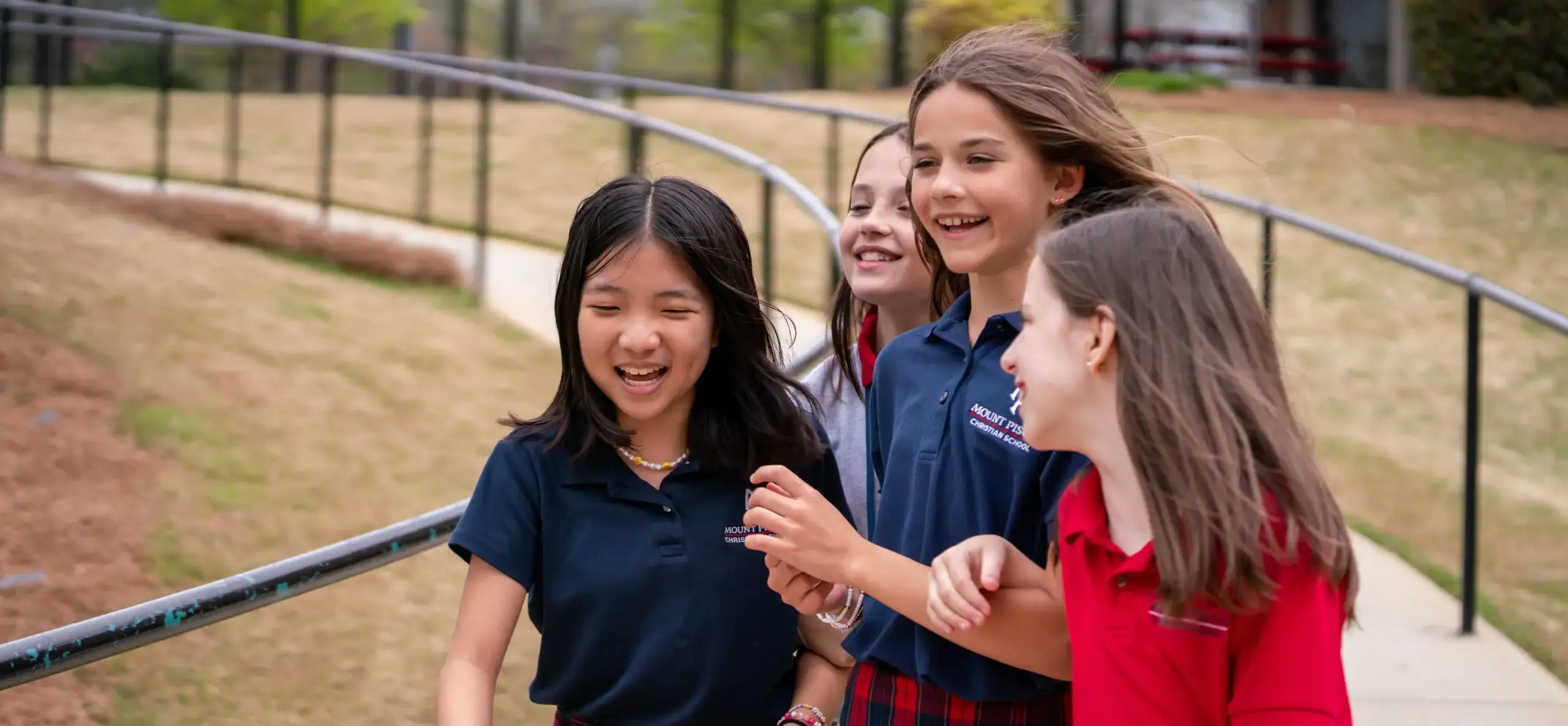 Four students walking outside 