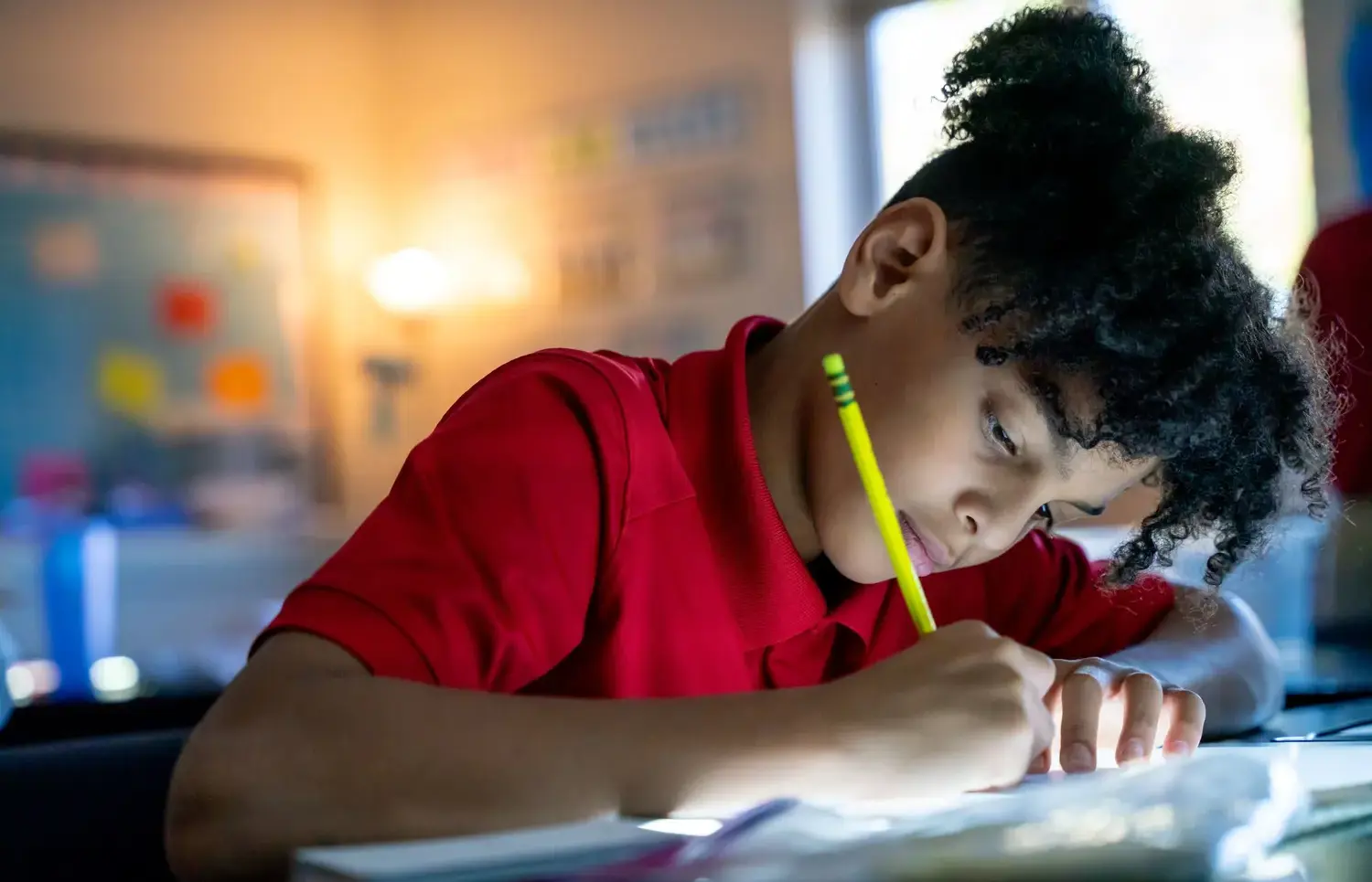 Student writing with a pen