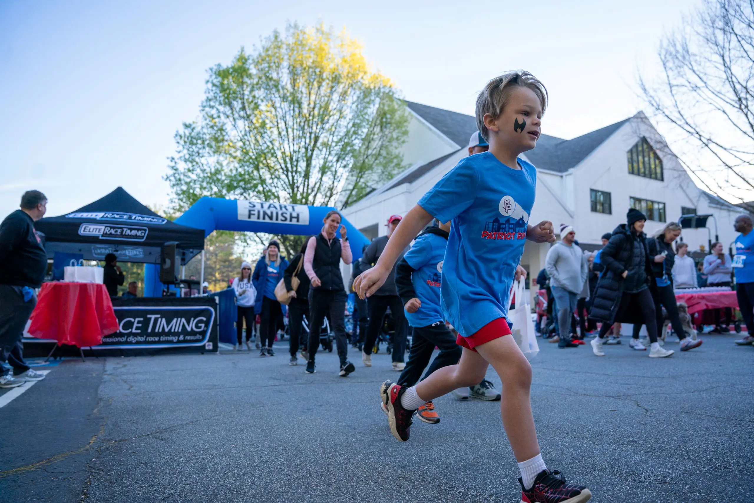 Children running from a blow-up starting line