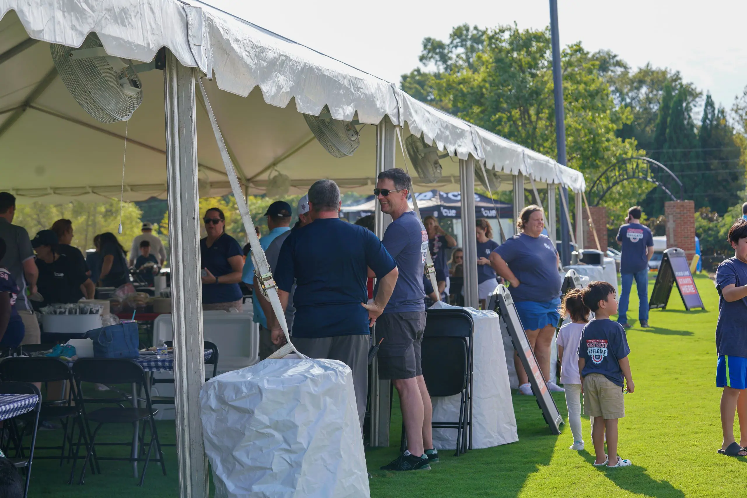 People standing under marquees