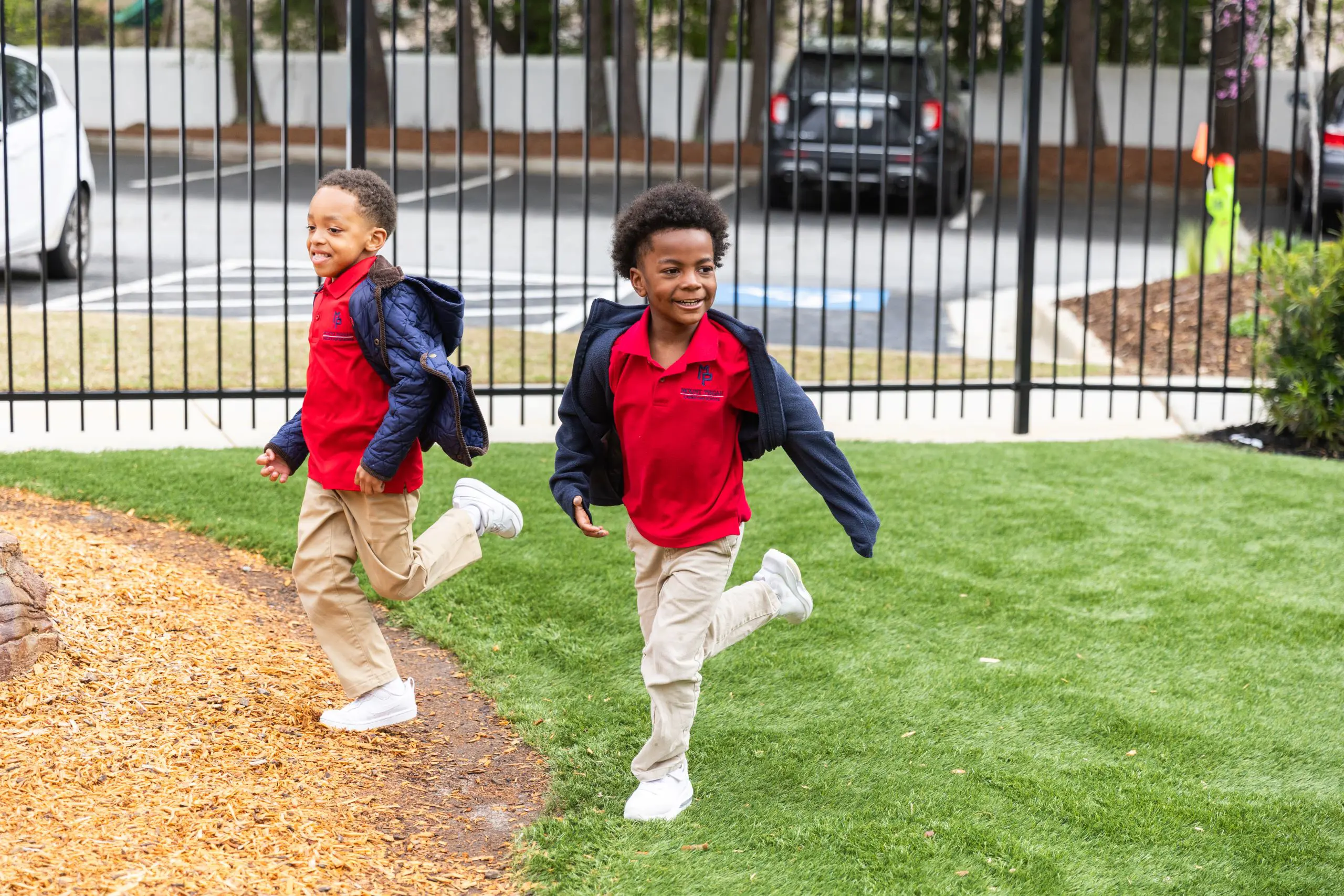 Two children playing on grass