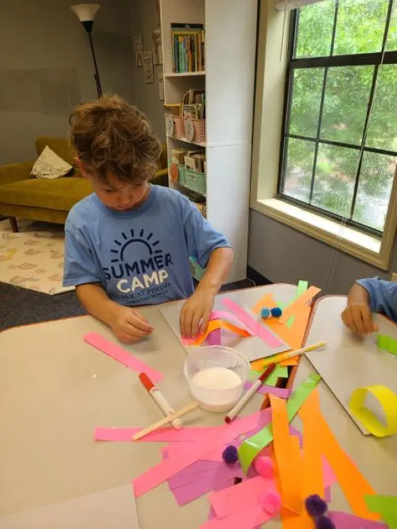 Child playing with colored paper