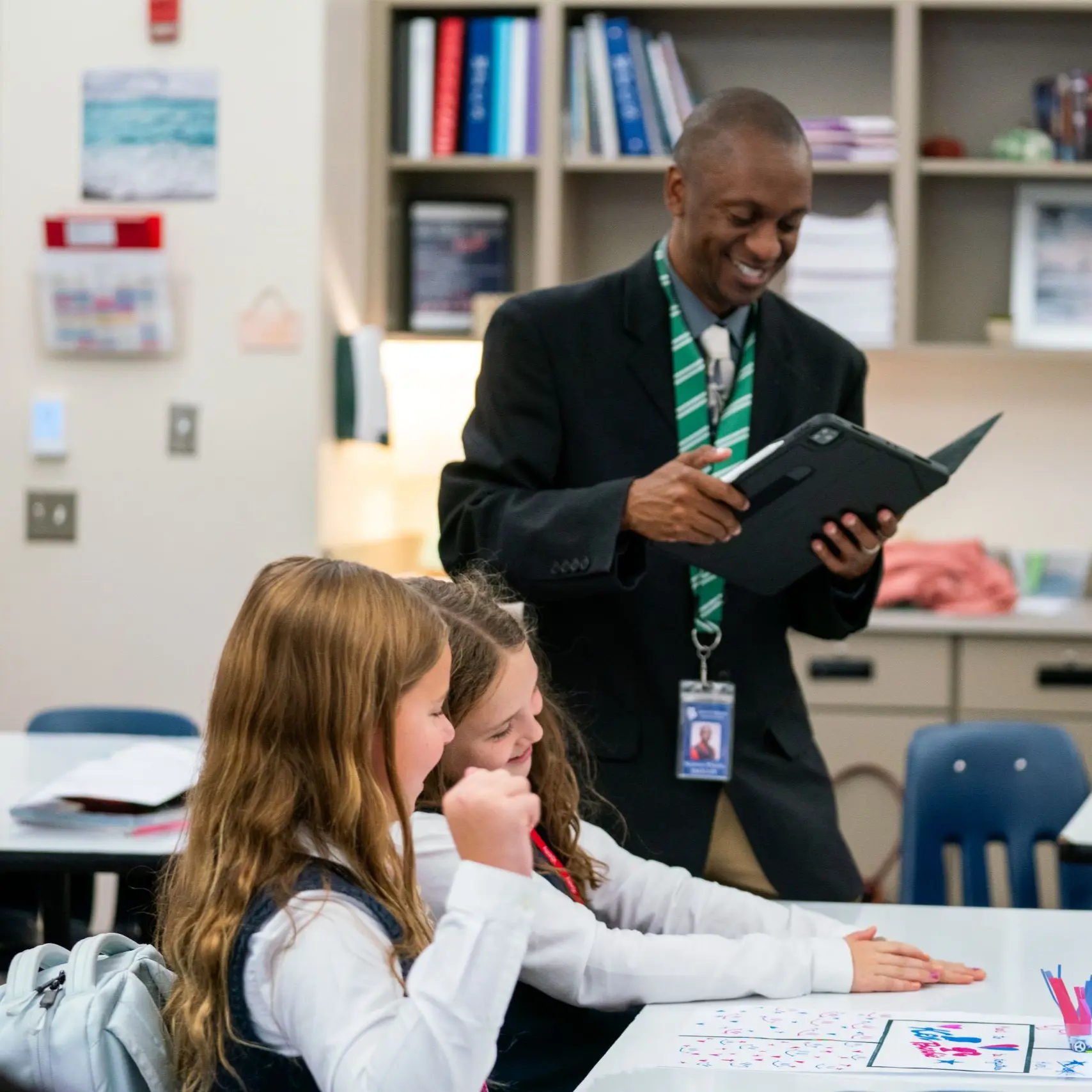 Teacher instructing children, smiling