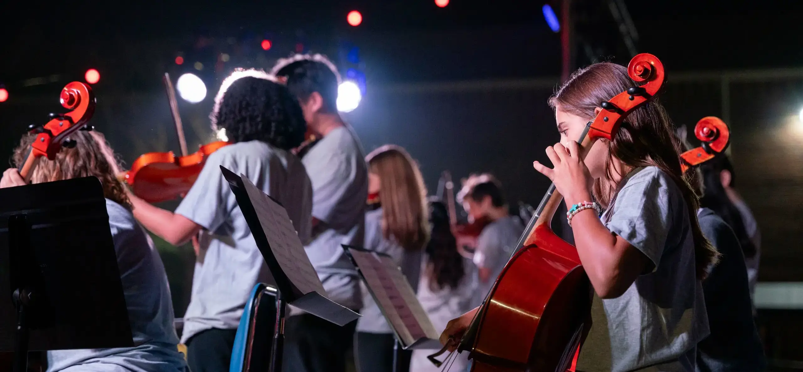 Students playing instruments onstage