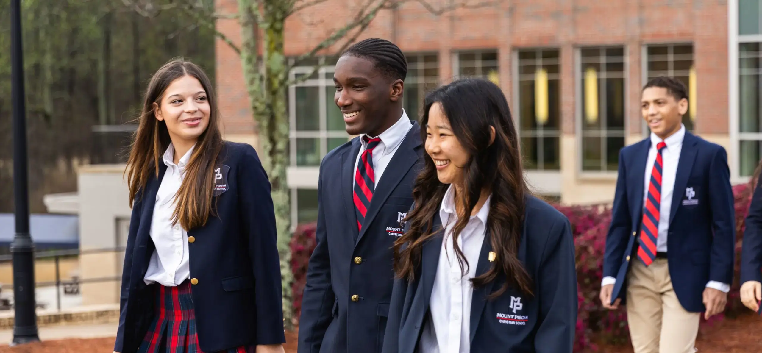 Four students walking outside