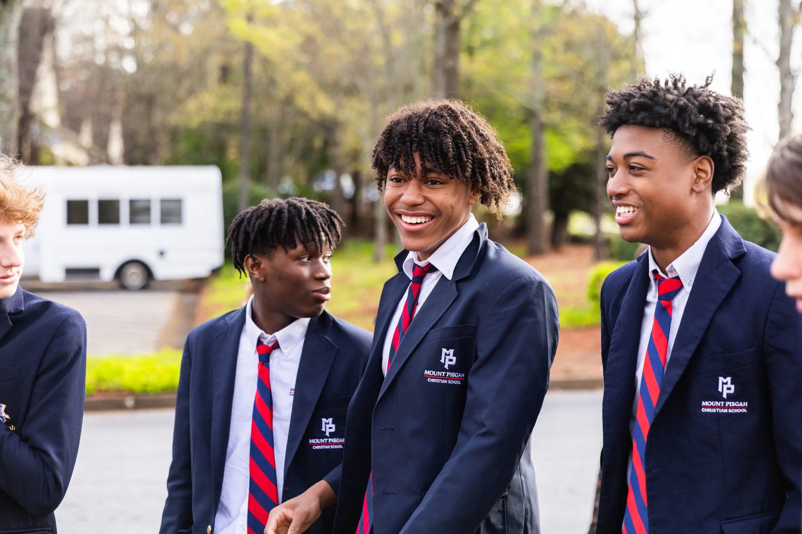 Students walking outside, smiling