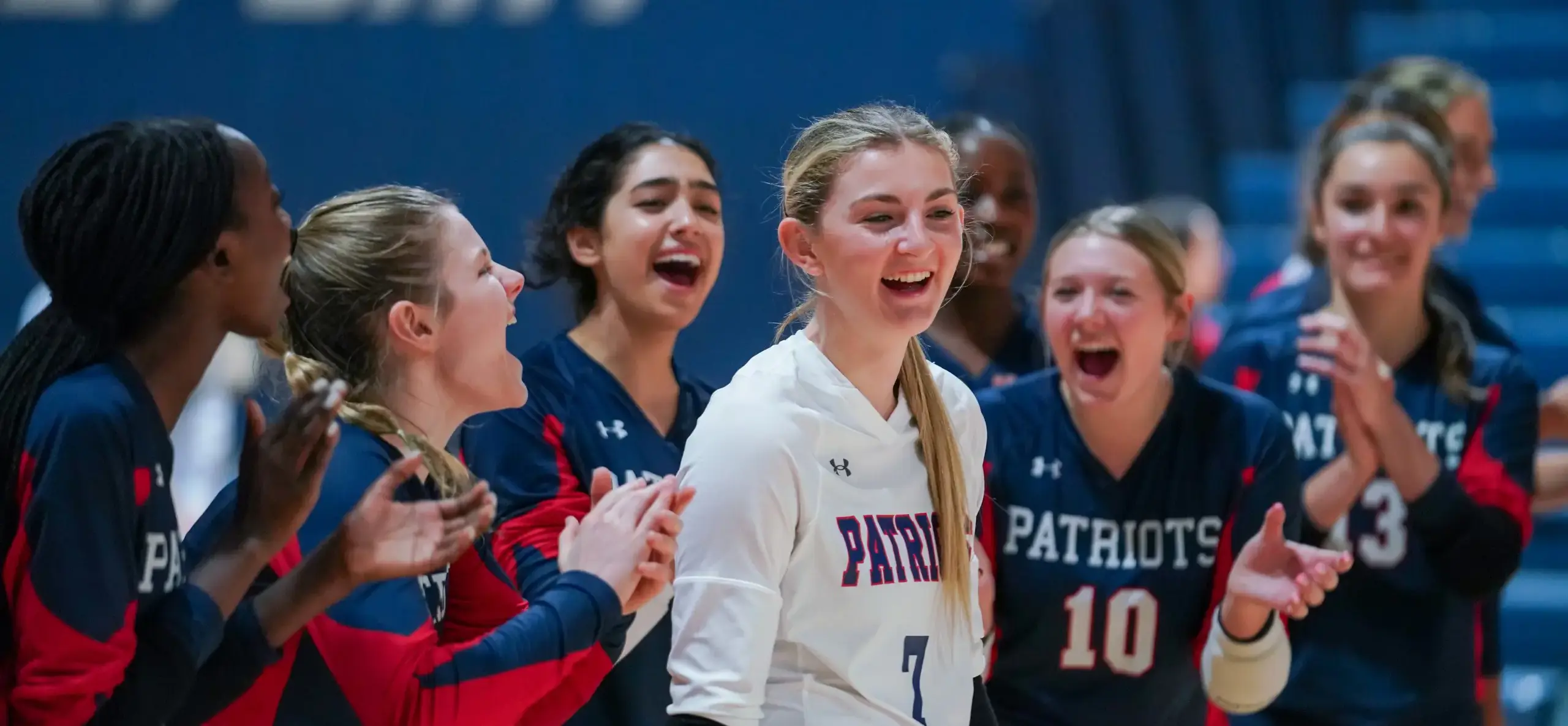 Volleyball teammates celebrate on court